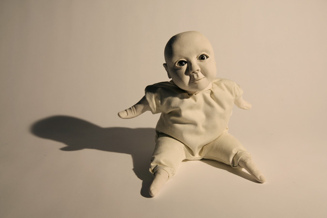 'Babies to love' Slip-cast porcelain from hand modelled wax and cast of my fingers, with glass eyes and textiles. Photography by Jonny Briggs.